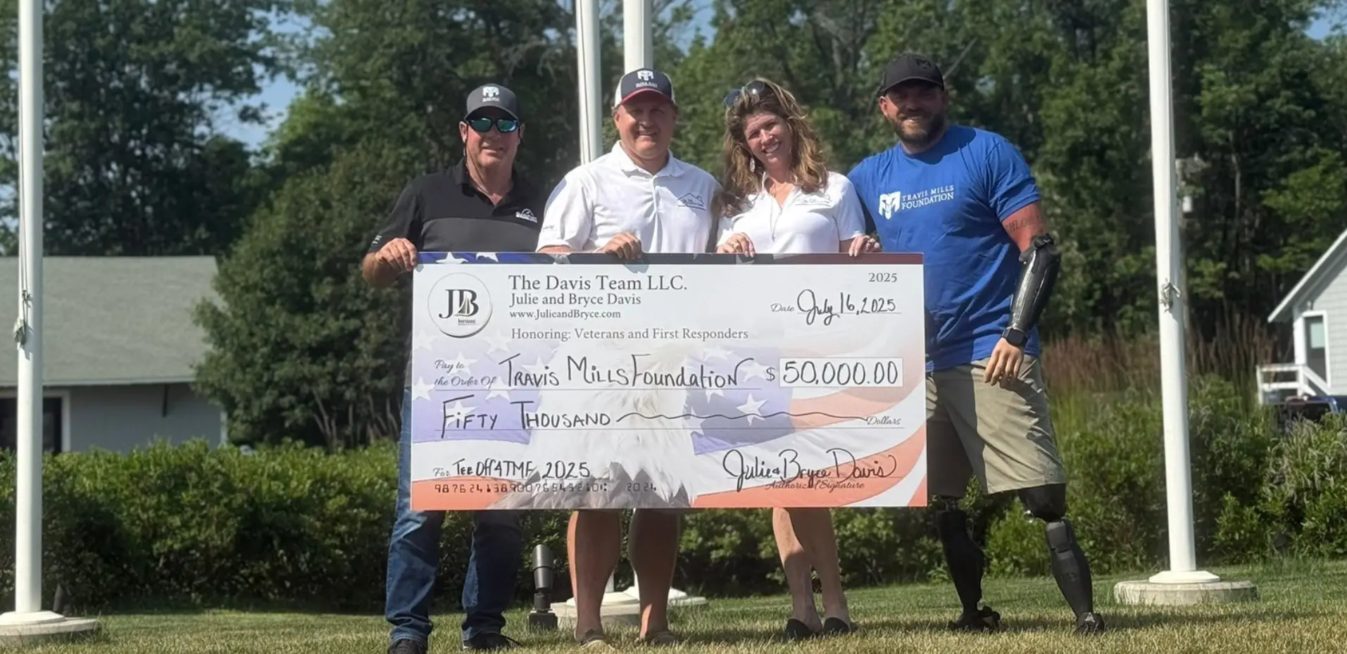 The Davis Team presenting a large check to the Travis Mills Foundation at the charity golf event.